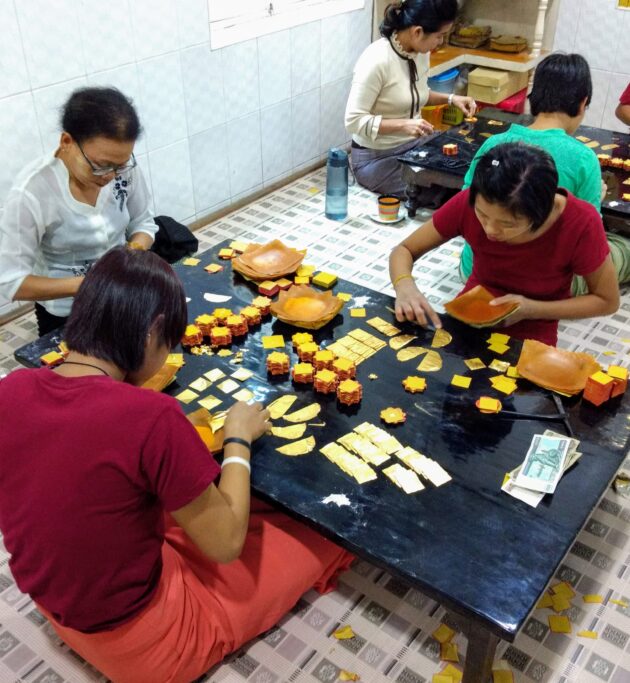 Gold hand-beaten into leaf, being sorted for sale