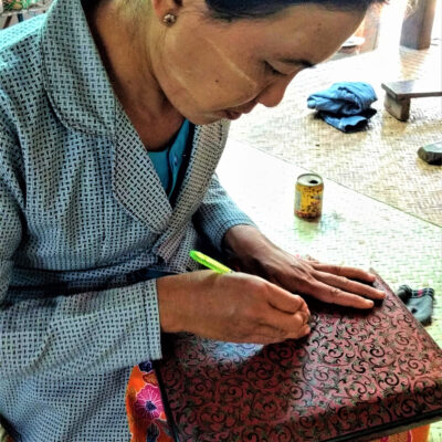 Delicate etching of each layer of lacquer. Most women wear ground thanaka root on face and arms. It has a sunscreen property but has become stylised like makeup